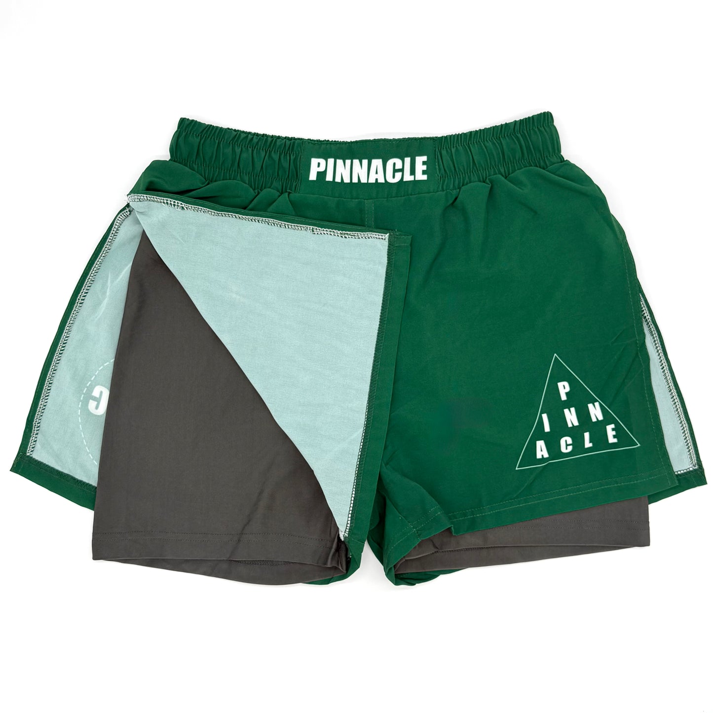 Green high-slit gladiator MMA shorts front view with built-in compression shorts exposed